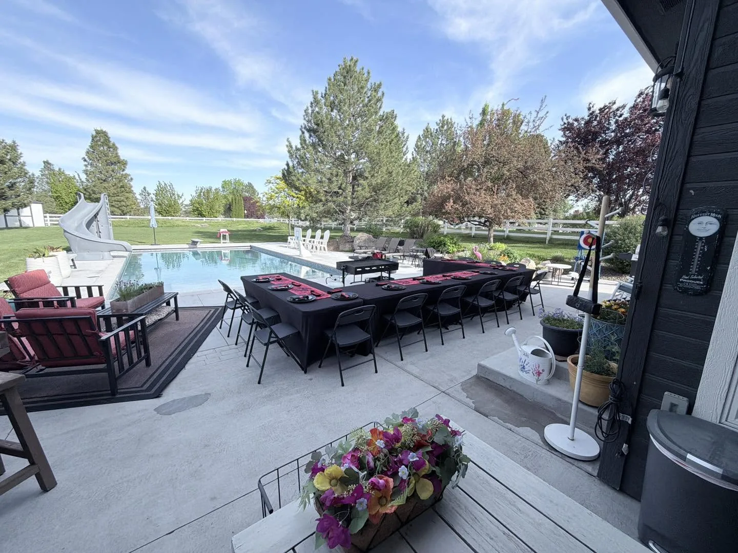 Hiroyuki Hibachi private catering setup — long black table with red place settings beside a pool for a backyard hibachi party in Idaho